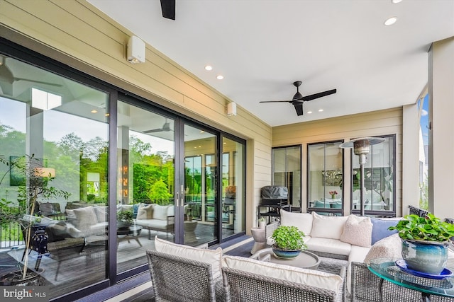 view of patio with an outdoor living space and ceiling fan