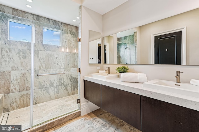 full bathroom with a shower stall, marble finish flooring, recessed lighting, and double vanity