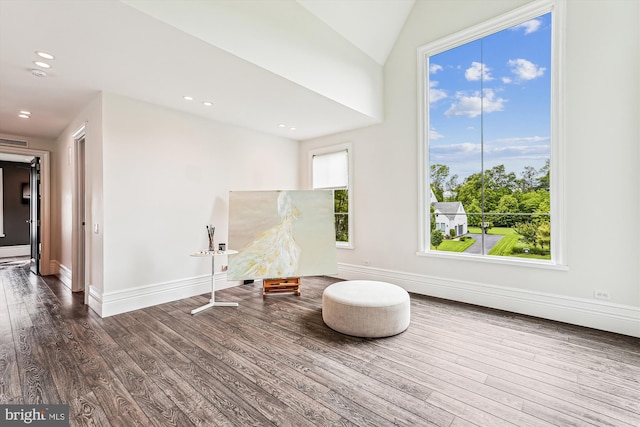 living area featuring wood finished floors, baseboards, and recessed lighting