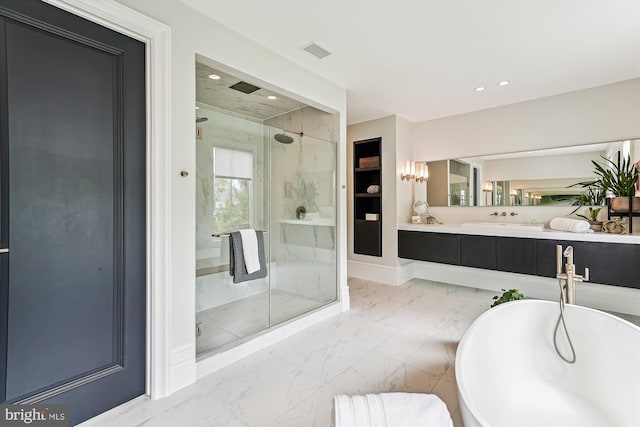 bathroom with marble finish flooring, a marble finish shower, a freestanding bath, recessed lighting, and vanity