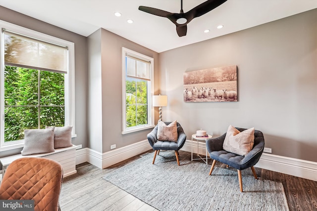 living area featuring baseboards, a ceiling fan, recessed lighting, and wood finished floors