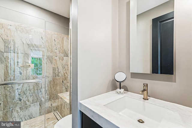bathroom featuring a shower stall, toilet, and vanity