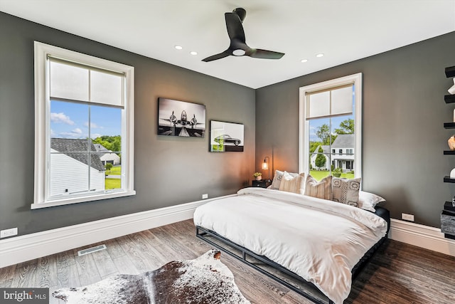 bedroom with multiple windows, wood finished floors, recessed lighting, baseboards, and ceiling fan