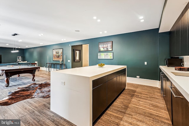 kitchen featuring light countertops, light wood-style floors, a kitchen island, billiards table, and recessed lighting