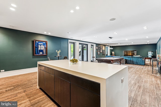 kitchen featuring light wood-style flooring, a kitchen island, recessed lighting, light countertops, and pool table