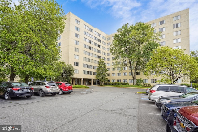 view of apartment building / complex featuring uncovered parking