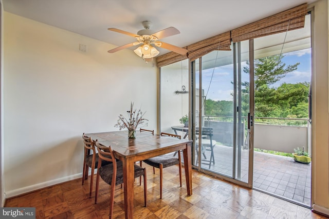 dining room featuring a ceiling fan and baseboards