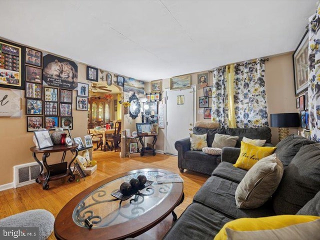 living area with wood finished floors and baseboards
