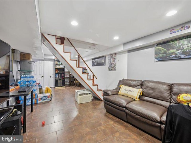 living area with stairway, recessed lighting, and stone finish flooring