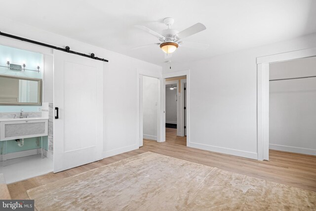 5 Winding Brook Dr, Cinnaminson, NJ 08077 - unfurnished bedroom with a barn door, wood finished floors, baseboards, and ensuite bath