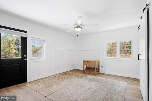 5 Winding Brook Dr, Cinnaminson, NJ 08077 - entryway with a barn door, wood finished floors, ceiling fan, and baseboards