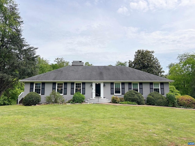 single story home with a chimney and a front yard