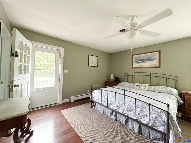 bedroom with wood finished floors, a baseboard radiator, and a ceiling fan