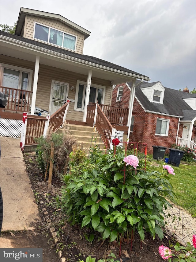 bungalow featuring a porch and brick siding