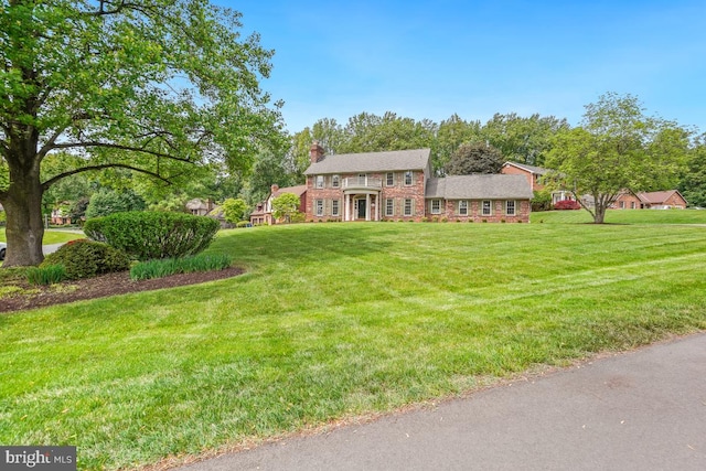 view of front of property featuring a front lawn and a chimney