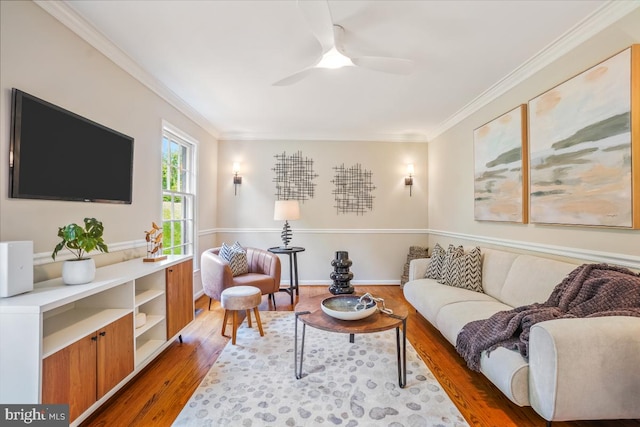 living room with wood finished floors, crown molding, and a ceiling fan