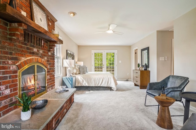 bedroom with access to exterior, carpet floors, a fireplace, baseboards, and ceiling fan