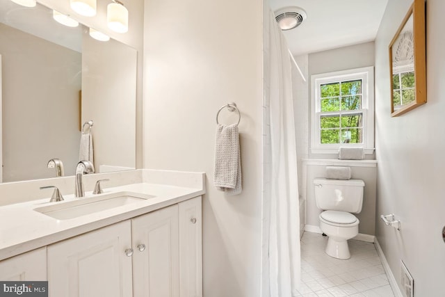 full bath featuring tile patterned flooring, toilet, vanity, and baseboards