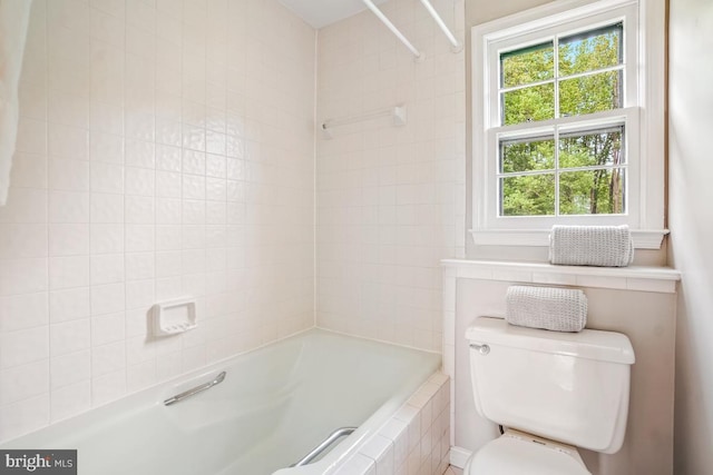 full bathroom with toilet and tiled shower / bath combo