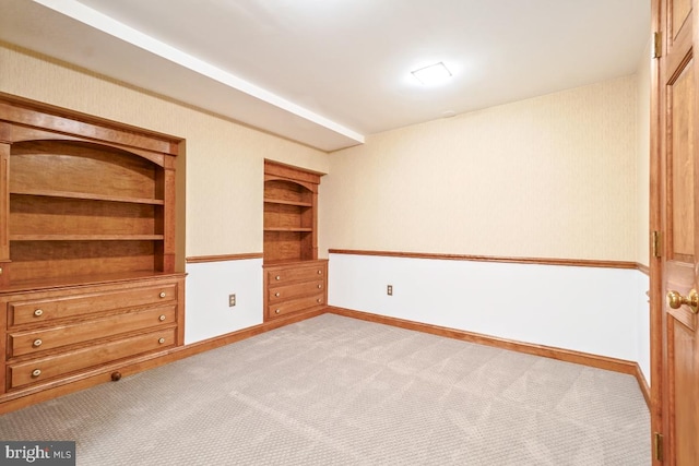 spare room with carpet and baseboards