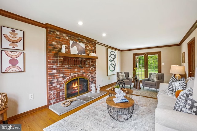 living room featuring crown molding, wood finished floors, a brick fireplace, baseboards, and recessed lighting