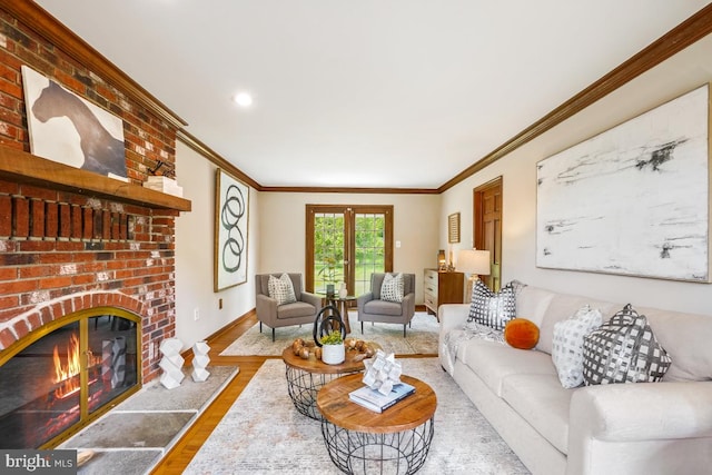 living room featuring ornamental molding, wood finished floors, a fireplace, baseboards, and recessed lighting