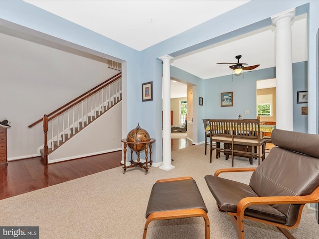9731 Wyndham Dr, Frederick, MD 21704 - carpeted living room with ornate columns, a ceiling fan, plenty of natural light, and baseboards