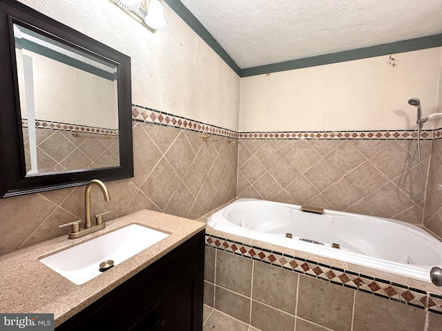 bathroom featuring tile walls, a tub with jets, and vanity