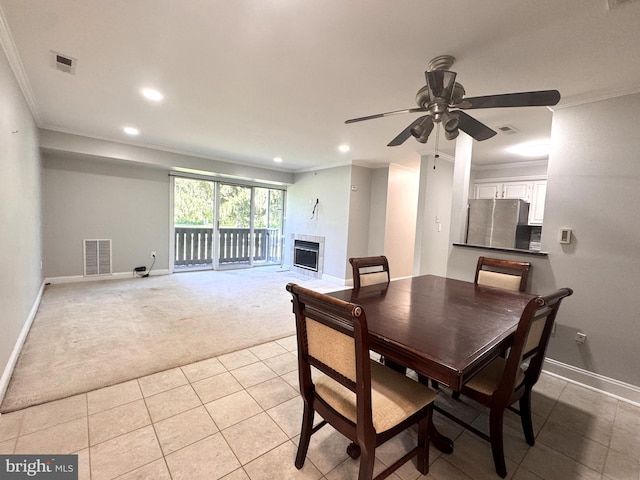 dining area with light carpet, recessed lighting, baseboards, ornamental molding, and a fireplace