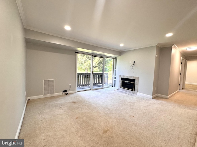 unfurnished living room featuring crown molding, baseboards, carpet flooring, recessed lighting, and a tiled fireplace