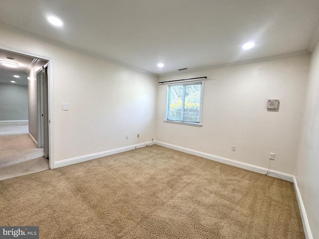 spare room featuring crown molding, light carpet, baseboards, and recessed lighting