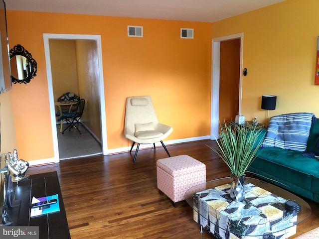 living area featuring wood finished floors and baseboards