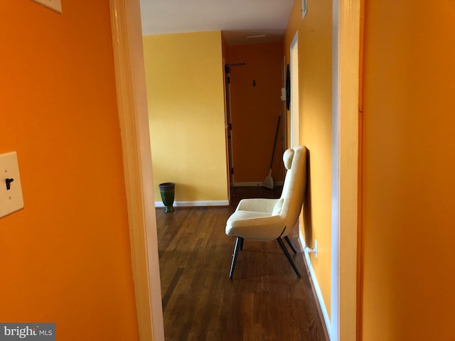 corridor with wood finished floors and baseboards