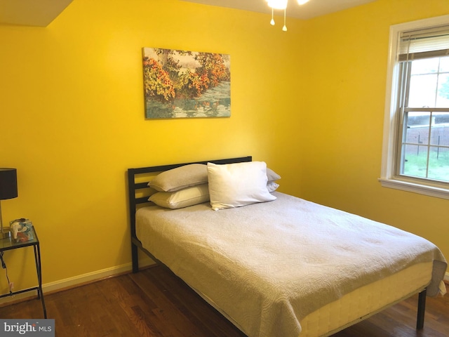 bedroom with wood finished floors and baseboards