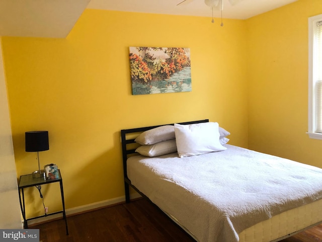 bedroom featuring wood finished floors and baseboards