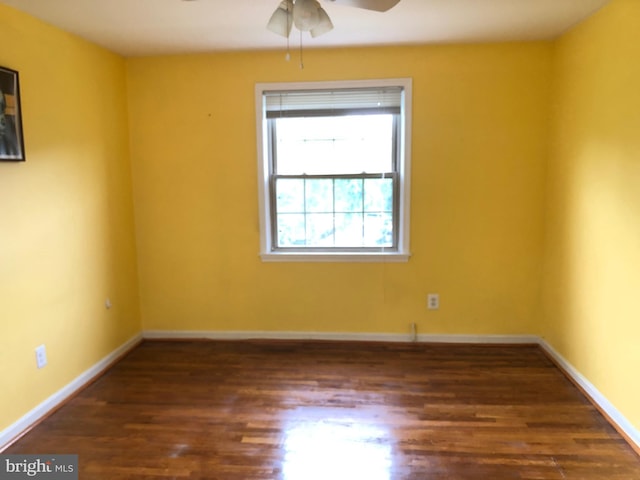 empty room featuring ceiling fan, wood finished floors, and baseboards