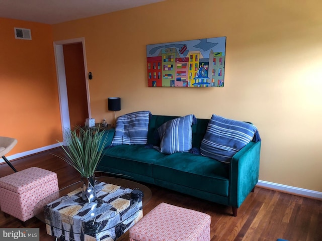 living area featuring baseboards and wood finished floors