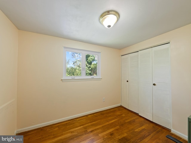5403 Rolling Rd, Springfield, VA 22151 - unfurnished bedroom featuring wood finished floors, baseboards, and a closet