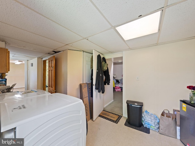 5403 Rolling Rd, Springfield, VA 22151 - finished basement with washer / clothes dryer, light flooring, a drop ceiling, and freestanding refrigerator