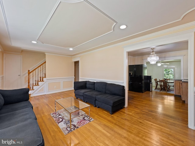 5403 Rolling Rd, Springfield, VA 22151 - living area featuring stairway, light wood-style floors, ornamental molding, a chandelier, and a wainscoted wall