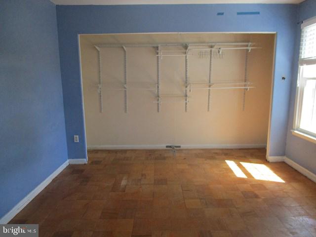 718 Quince Orchard Blvd Unit 718, Gaithersburg, MD 20878 - unfurnished bedroom with a closet, multiple windows, and baseboards