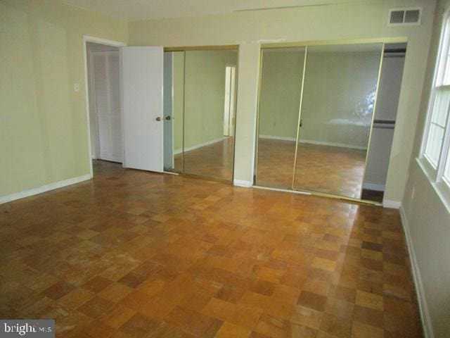 718 Quince Orchard Blvd Unit 718, Gaithersburg, MD 20878 - unfurnished bedroom with two closets and baseboards