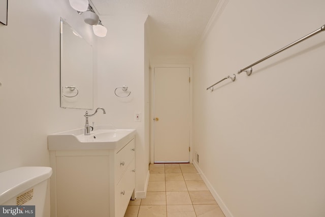 bathroom featuring tile patterned floors, vanity, crown molding, and toilet