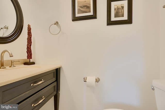 bathroom featuring toilet and vanity