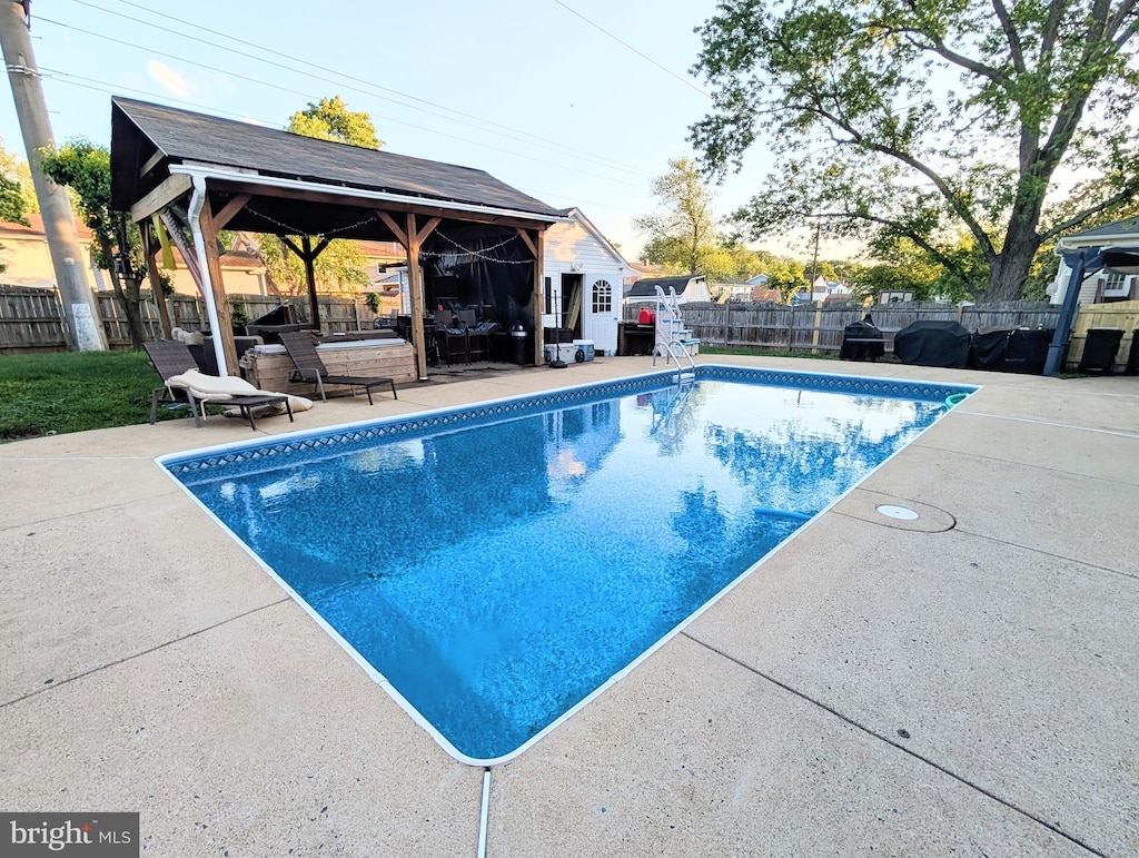 view of pool with a gazebo, a fenced backyard, and a patio area