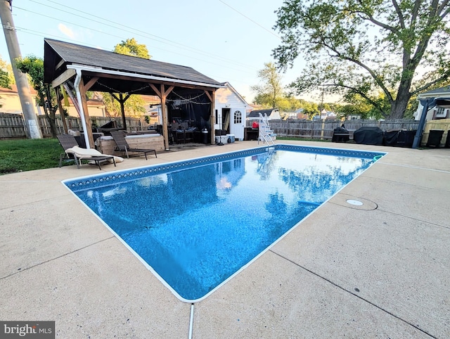 view of pool with a gazebo, a fenced backyard, and a patio area