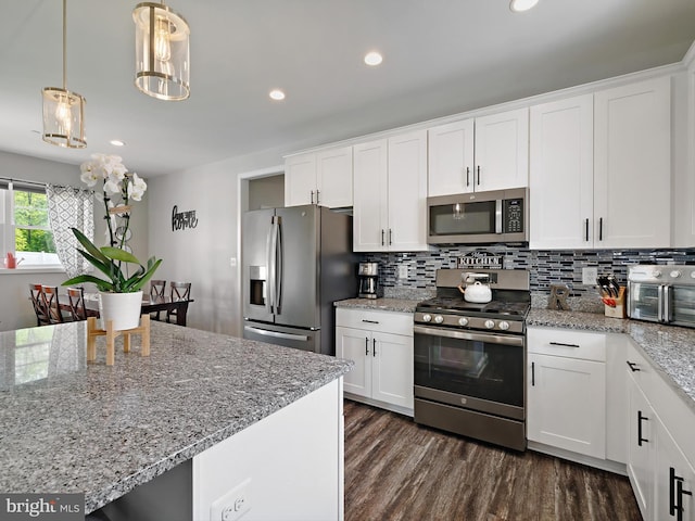 16016 Ambleside Ct, Hughesville, MD 20637 - kitchen with stainless steel appliances, decorative backsplash, white cabinetry, dark wood finished floors, and decorative light fixtures