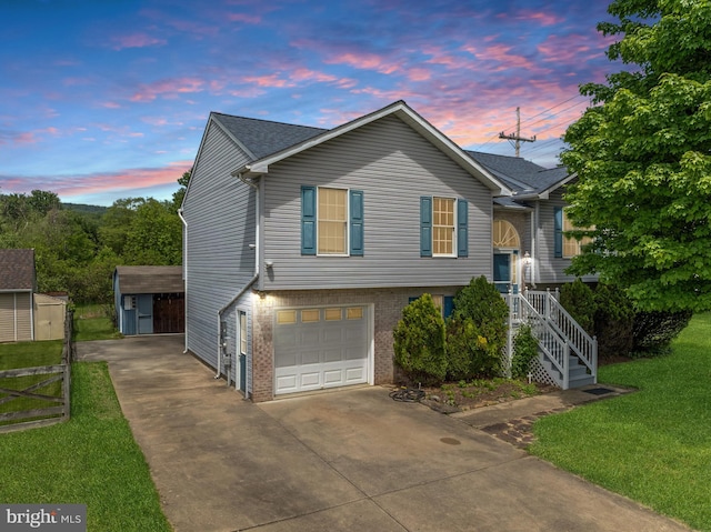 115 Emmitsburg Rd, Thurmont, MD 21788 - view of front of home featuring driveway, brick siding, an attached garage, a storage unit, and an outbuilding
