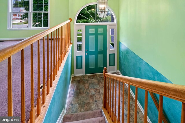 115 Emmitsburg Rd, Thurmont, MD 21788 - entrance foyer featuring stone finish flooring, baseboards, a chandelier, and stairs