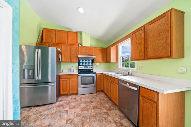 115 Emmitsburg Rd, Thurmont, MD 21788 - kitchen featuring stainless steel appliances, a sink, vaulted ceiling, stone finish floors, and brown cabinetry